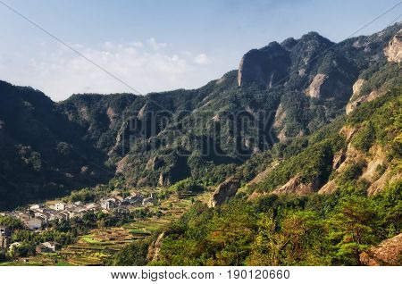 The village of Shanglingyancun and a terraced tea garden surrounded by the mountains in the Fangdong scenic area of Yandangshan located in Zhejiang province China.