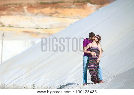 lovers on romantic travel honeymoon vacation summer holidays romance. Injoy couple on the beach with white sand, caucasian woman and man embracing and kissing outdoors
