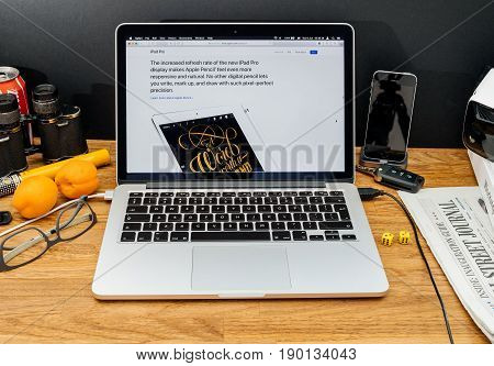 PARIS FRANCE - JUNE 6 2017: Apple Computers website on MacBook Retina in creative environment showcasing latest news from Apple at WWDC 2017 - iPad pencil on the iPad pro caligraphy