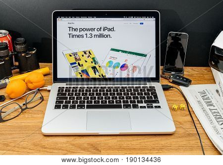 PARIS FRANCE - JUNE 6 2017: Apple Computers website on MacBook Retina in creative environment showcasing latest news from Apple at WWDC 2017 - The power of ipad. Times 1.3 message on display