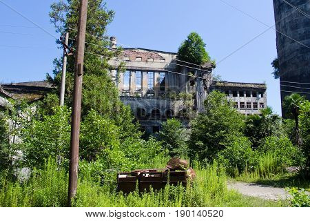 Abandoned overgrown ruins of destroyed by war Tkvarcheli (Tquarhcal) power plant, Abkhazia, Georgia
