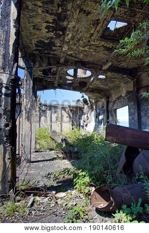 Abandoned overgrown ruins of destroyed by war Tkvarcheli (Tquarhcal) power plant, Abkhazia, Georgia