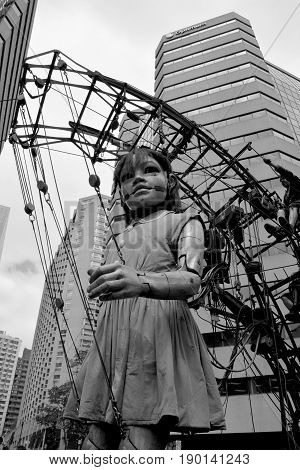 MONTREAL QUEBEC CANADA 19 05 17: The little giant girl walking in the street of Montreal for the 375e anniversary of the city, by Royal De Luxe company Nantes France