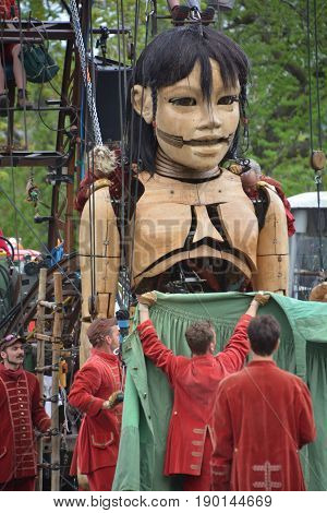 MONTREAL QUEBEC CANADA 19 05 17: The little giant girl walking in the street of Montreal for the 375e anniversary of the city, by Royal De Luxe company Nantes France