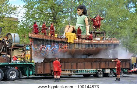 MONTREAL QUEBEC CANADA 19 05 17: The little giant girl walking in the street of Montreal for the 375e anniversary of the city, by Royal De Luxe company Nantes France