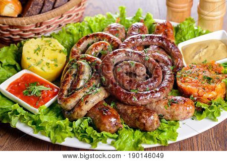 Assorted Bavarian sausages garnished with greens and sauces