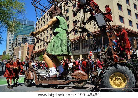 MONTREAL QUEBEC CANADA 19 05 17: The little giant girl walking in the street of Montreal for the 375e anniversary of the city, by Royal De Luxe company Nantes France