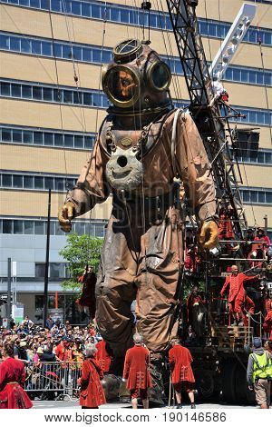 MONTREAL QUEBEC CANADA 19 05 17: The giant deep-sea diver sleeping in the street of Montreal for the 375e anniversary of the city, by Royal De Luxe company Nantes France