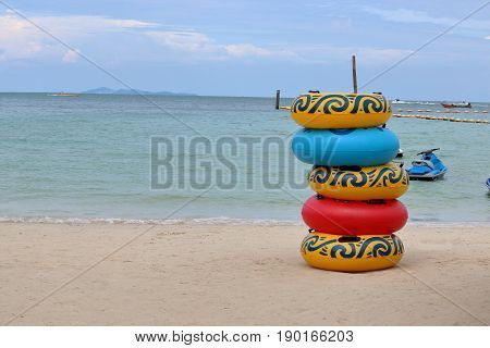 Stack of colorful floating rings on the beachswim ring rubber ring swimming tubes
