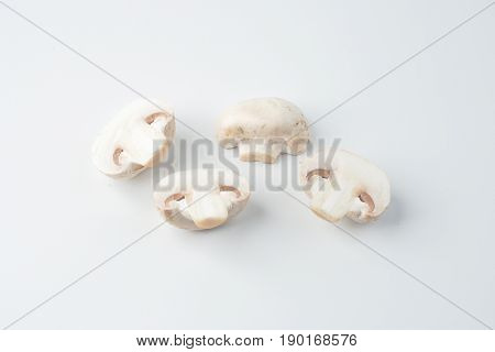 Isolated sliced white mushrooms on white background