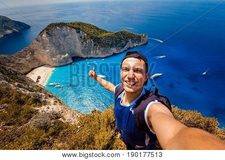 A guy doing selfie on a background of a shipwreck
