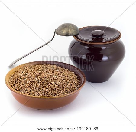 The Composition Of The Buckwheat Groats In A Clay Pial Next To A Clay Pot And A Copper Spoon,