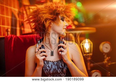 Redhaired girl in headphones with unusual makeup at the disco