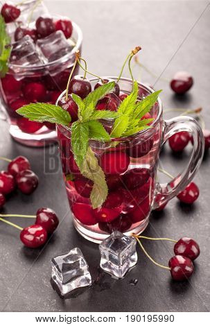 Ice cream and cherry juice on black stone board
