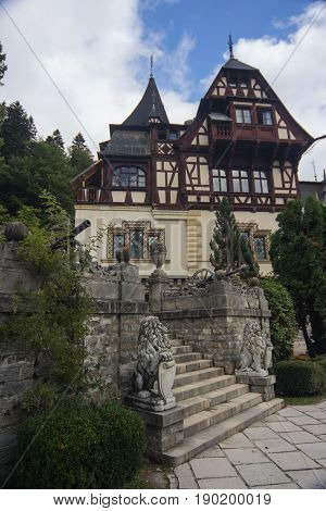 close view at part the Peles Castle Sinaia Romania Europe. with stairs between two statues of lions and cannons