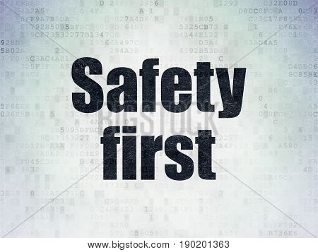 Privacy concept: Painted black word Safety First on Digital Data Paper background