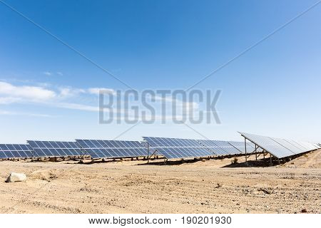 solar panels on the gobi against abundant sunshine sky clean energy background