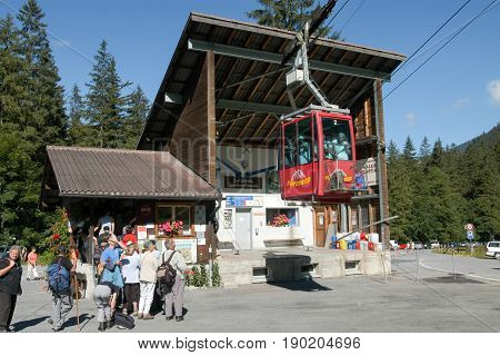 People Waiting In Line To Get On The Cable Car