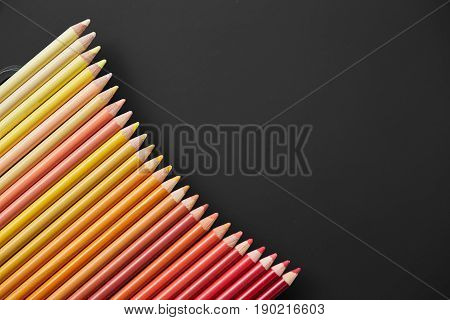 Colour pencils isolated on black background close up