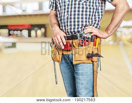 detail of handyman with toolsbelt and blurred background