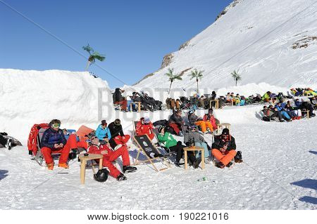 People Relaxing At The Restaurant On The Swiss Alps