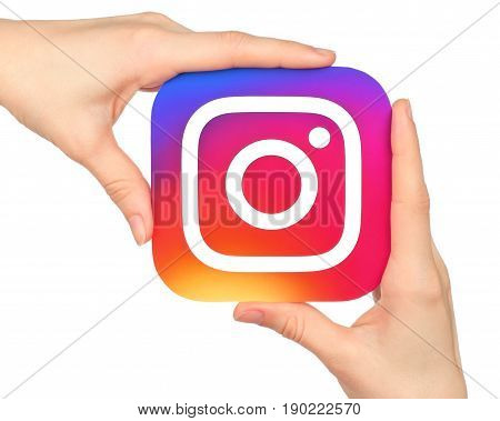 Kiev Ukraine - January 20 2016: Hands hold Instagram icon printed on paper. Instagram is an online mobile photo-sharing video-sharing service