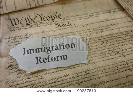 Immigration newspaper headline on copy of US Constitution