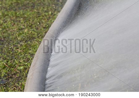 water leaking from hole in a hose.