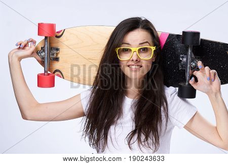 Woman with longboard in hands, woman and skateboard in studio.