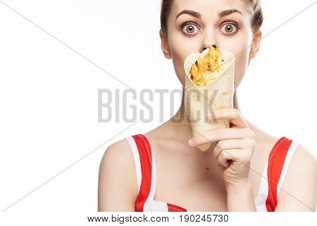 Woman with food in hand, lavash in hands.
