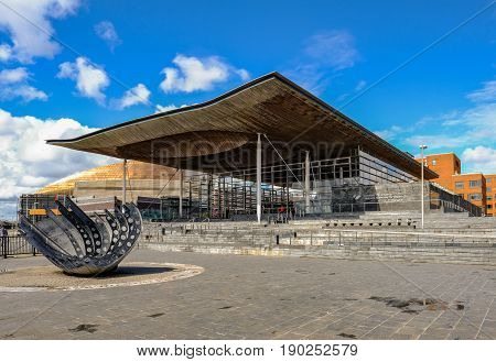Cardiff Bay Cardiff Wales - May 20 2017: Sinedd National Assembly building. Front view with sculpture in the foreground.