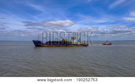 Cardiff Bay Cardiff Wales - May 20 2017: UKD Bluefin dredger out at sea on a blue sky summer day.