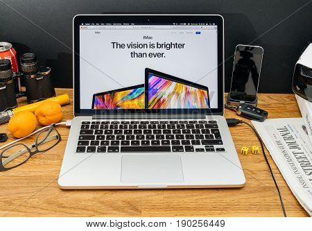 PARIS FRANCE - JUNE 6 2017: Apple Computers website on MacBook Retina in creative environment showcasing latest news from Apple at WWDC 2017 - new faster iMac computer launch