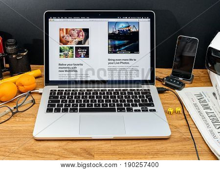 PARIS FRANCE - JUNE 6 2017: Apple Computers website on MacBook Retina in creative environment showcasing latest macOS High Sierra from Apple at WWDC 2017 - new photo app organization files