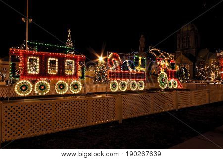 Taunton Massachusetts USA - December 28 2007: Train made of lights among Christmas decorations on the Taunton Green in Taunton Massachusetts