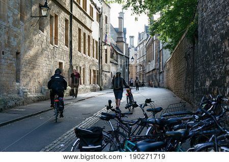 OXFORD, UK - MAY 22, 2017: Cyclists and pedestrians on the street in Oxford, home of famous University of Oxford.