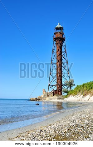 Old Lighthouse On The Beach Near The Sea. Lighthouse On The Coast Of The Island Dzharylgach.