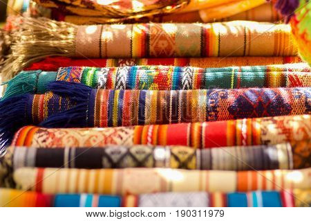 OTAVALO, ECUADOR - MAY 17, 2017: The typical andean fabrics sold on the handicrafts market of Otavalo, Ecuador.