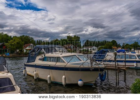 Boats Anchored On The Bank Of The River, Residential Houses On The Other Side, Beautiful Broad River