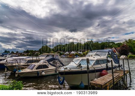 Boats Anchored On The Bank Of The River, Residential Houses On The Other Side, Beautiful Broad River