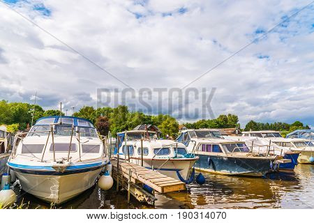 Boats Anchored On The Bank Of The River, Residential Houses On The Other Side, Beautiful Broad River