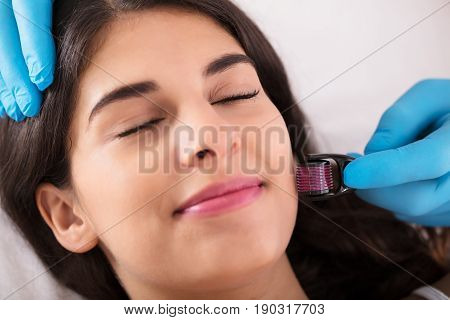 Woman Having Facial Treatment On Her Face In Beauty Salon