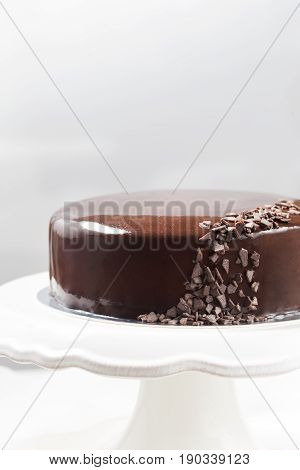Chocolate mousse cake with mirror glaze on a cale stand