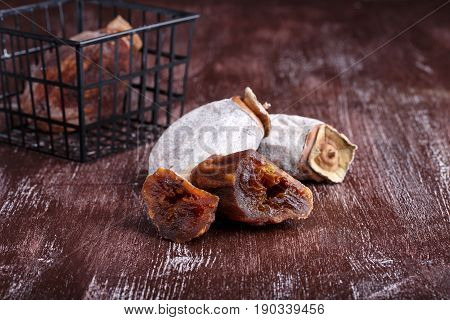 Dried persimmon fruits on dark brown background
