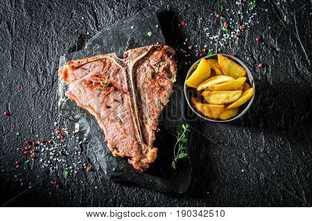 Closeup Of Chips And Tbone Steak On The Black Rock