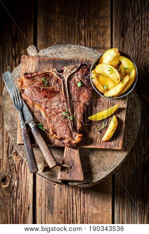 Delicious Tbone Steak And Chips On Old Barrel