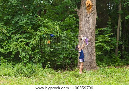 happy family - Mother throws up baby, playing outdoors.