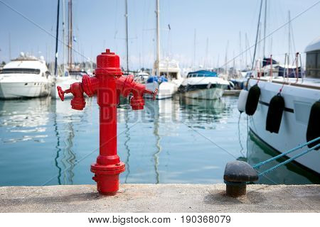 Marine fire hydrant on the quay in front of the yachts, the Mediterranean sea, Greece