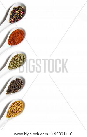 Top View Of Assorted Aromatic Seasonings In Ceramic Spoons Isolated On White