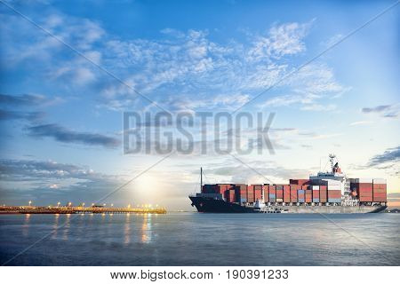 Logistics and transportation of International Container Cargo ship in the ocean at twilight sky Freight Transportation Shipping